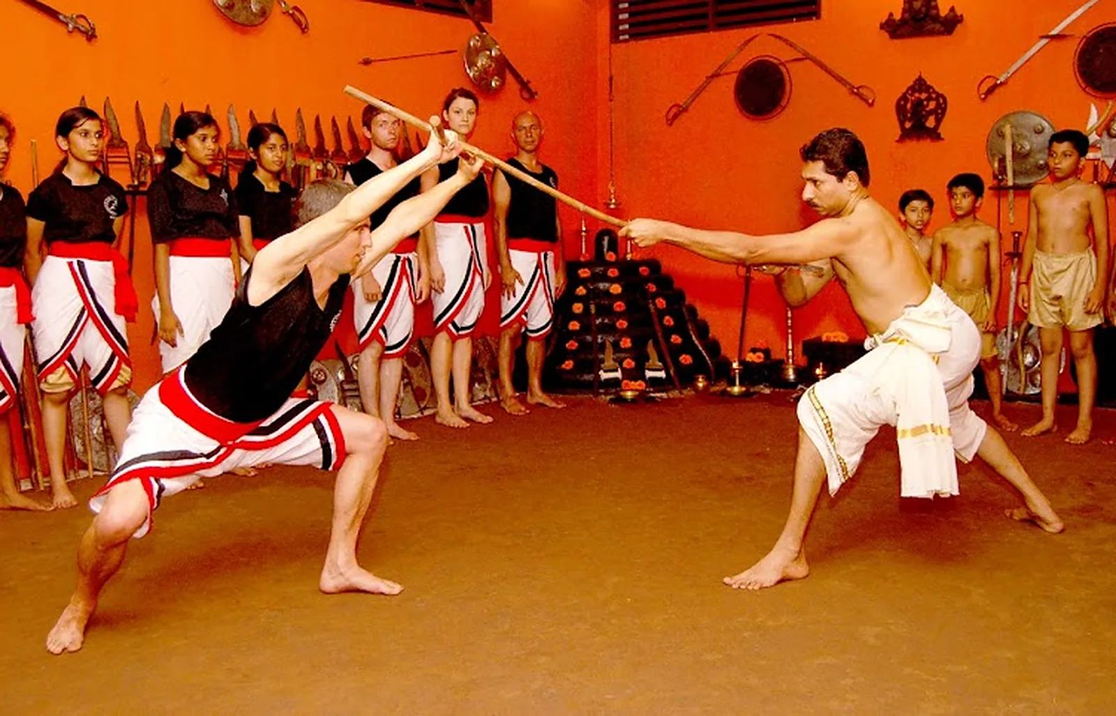 Kalari students and gurukkal in a training session inside the kalari